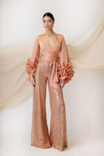 Maestri Haute Couture due pezzi pantalone largo completamente fatto di paillette casacca colore pesca maniche lunghe arricchiate ai polsi allacciatura kimono